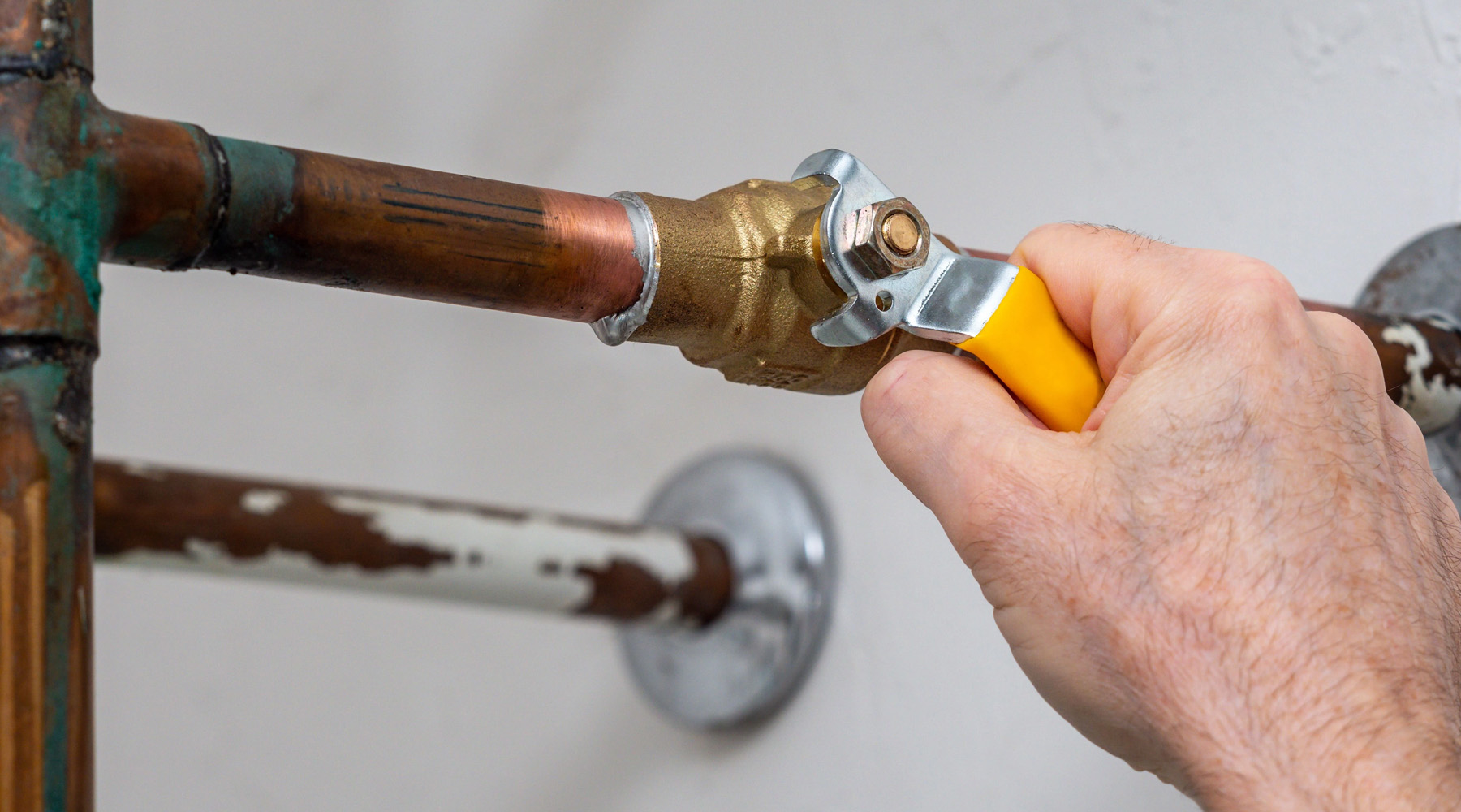 home owner testing water shut off valve