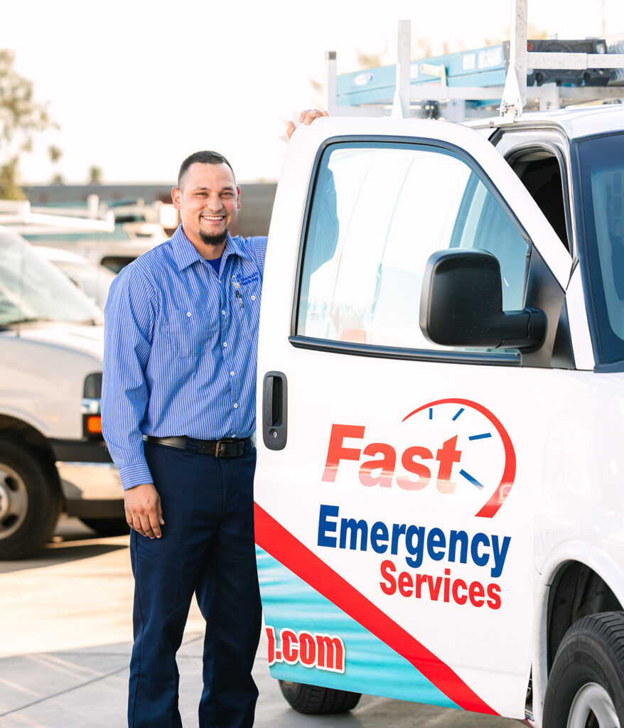 Emergency service technician ready to assist, standing by the service van.
