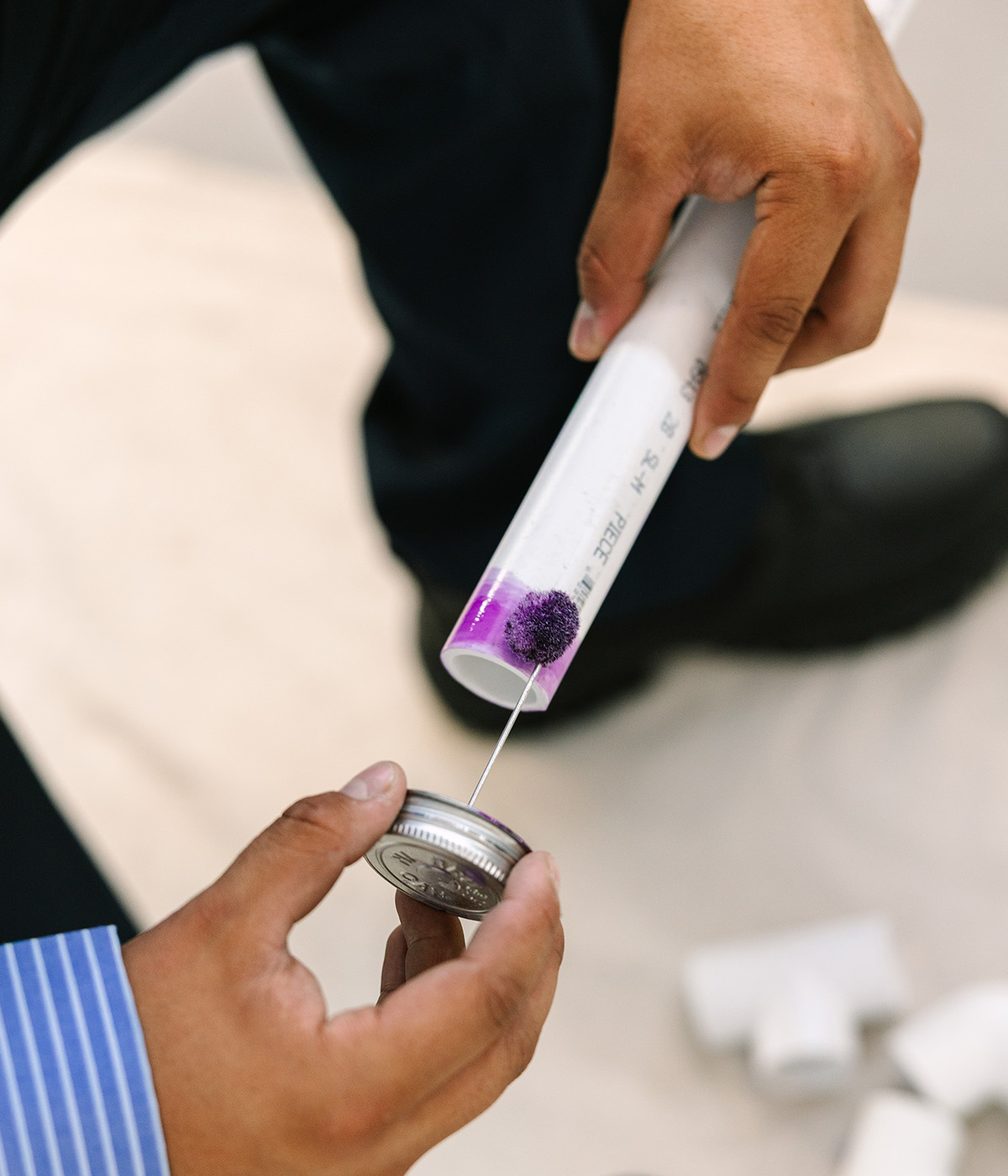 Al Coronado applying primer to PVC pipe