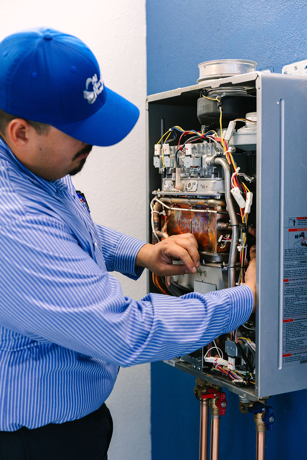 Al Coronado technician working on a water heater repair.