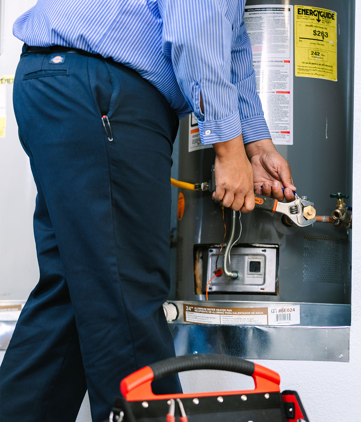 Al Coronado plumber conducting repairs on a residential water heater