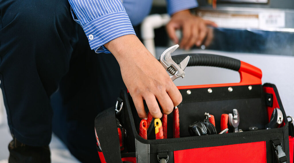 grabbing wrench out of bag