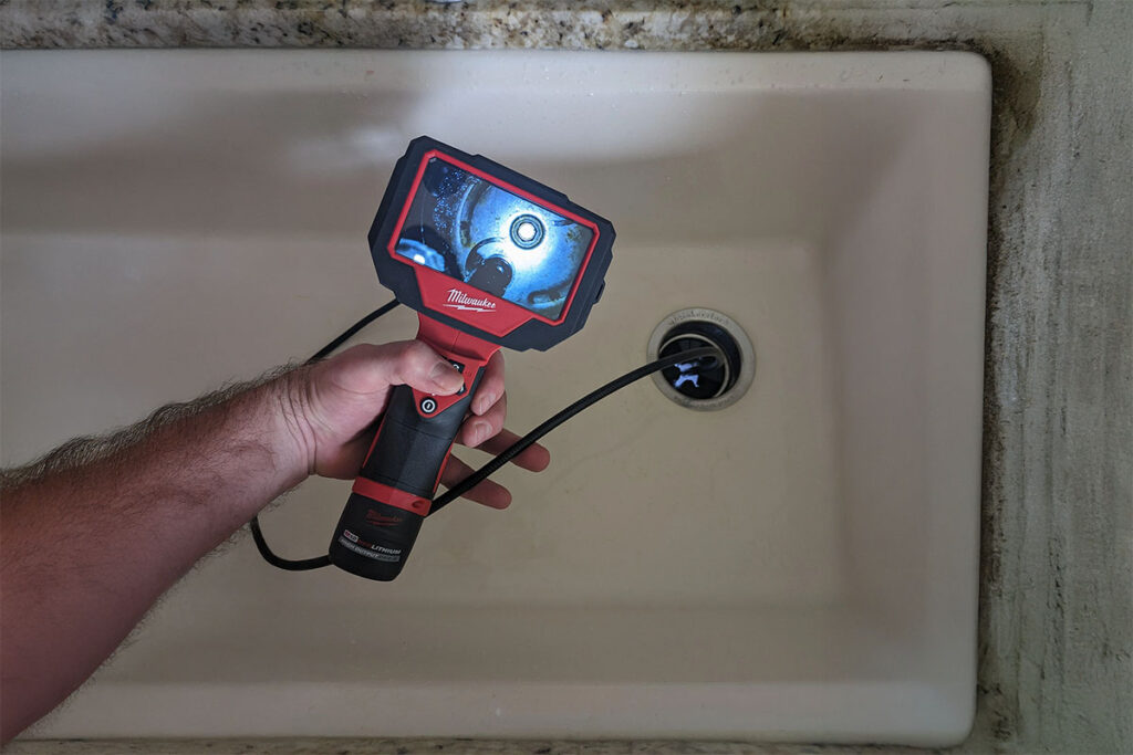 Plumber using camera to check sewer